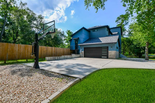 a front view of a house with a yard and a garden