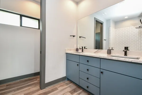 a bathroom with a double vanity sink and mirror