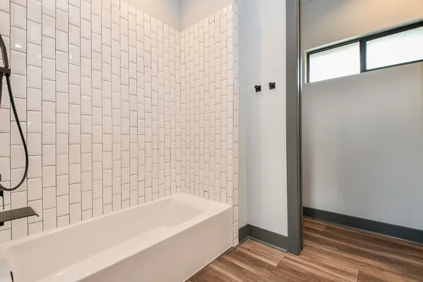 a bathroom with a bathtub and shower