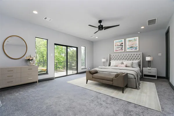 a spacious bedroom with a bed a dresser and next to a window