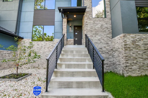 a view of a brick house with large windows