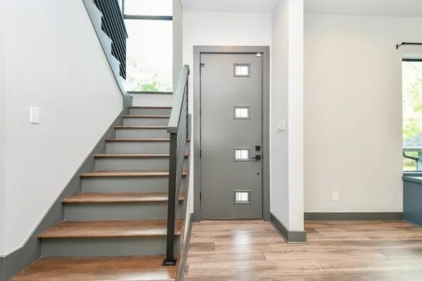 a view of entryway with wooden floor and stairs