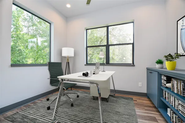 a view of a workspace with furniture and a window
