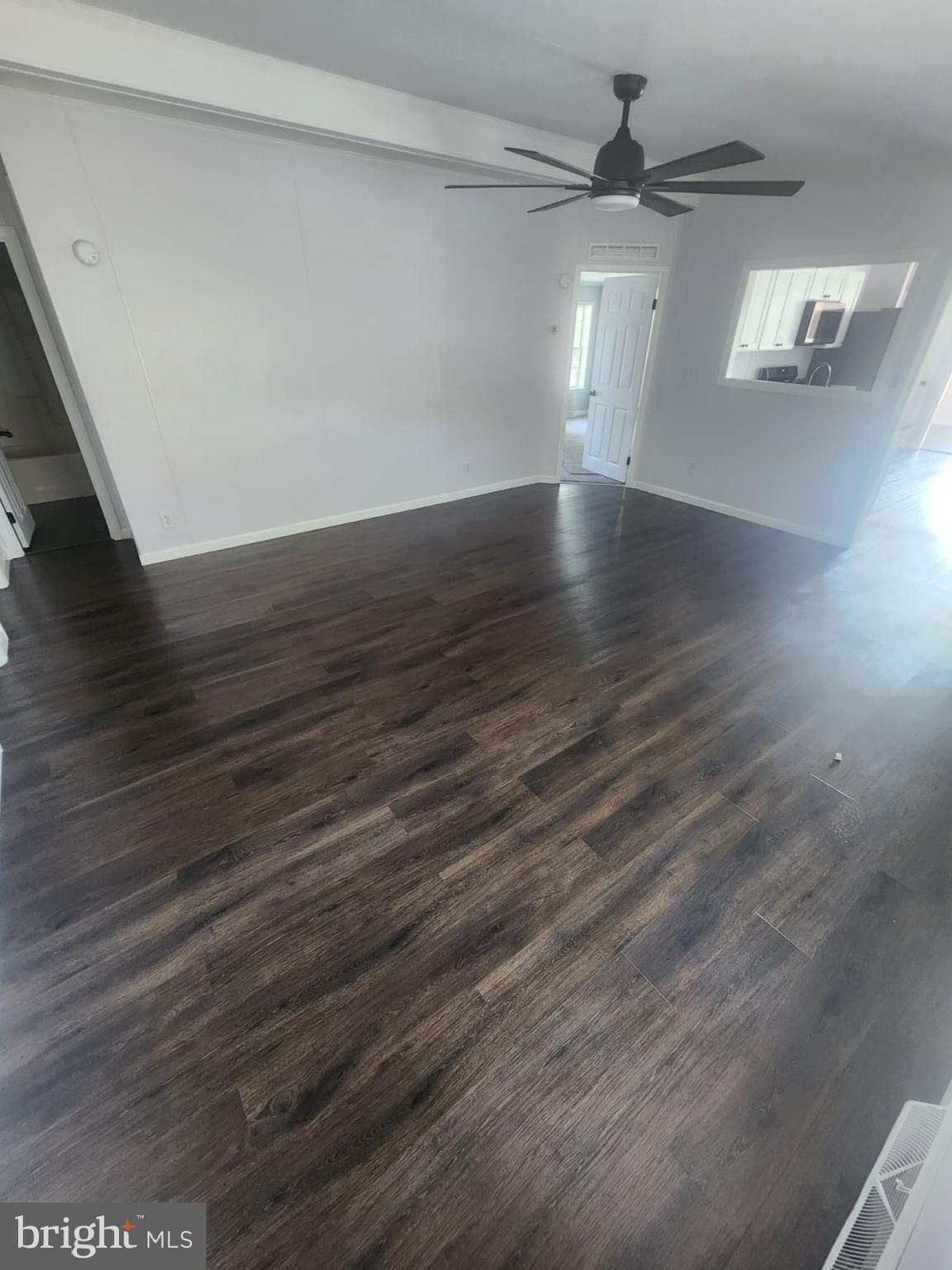 2110 Mays Landing Road, Unit 199 Millville, NJ 08332 - Photo 11 of 18 a view of an empty room with wooden floor and a window