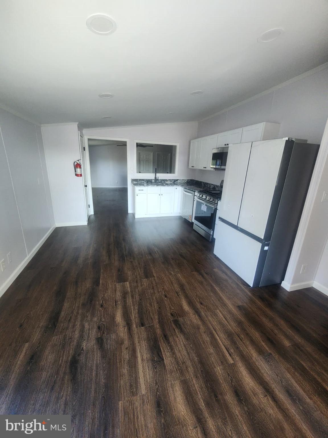 2110 Mays Landing Road, Unit 199 Millville, NJ 08332 - Photo 14 of 18 a view of a living room hardwood floor and a kitchen