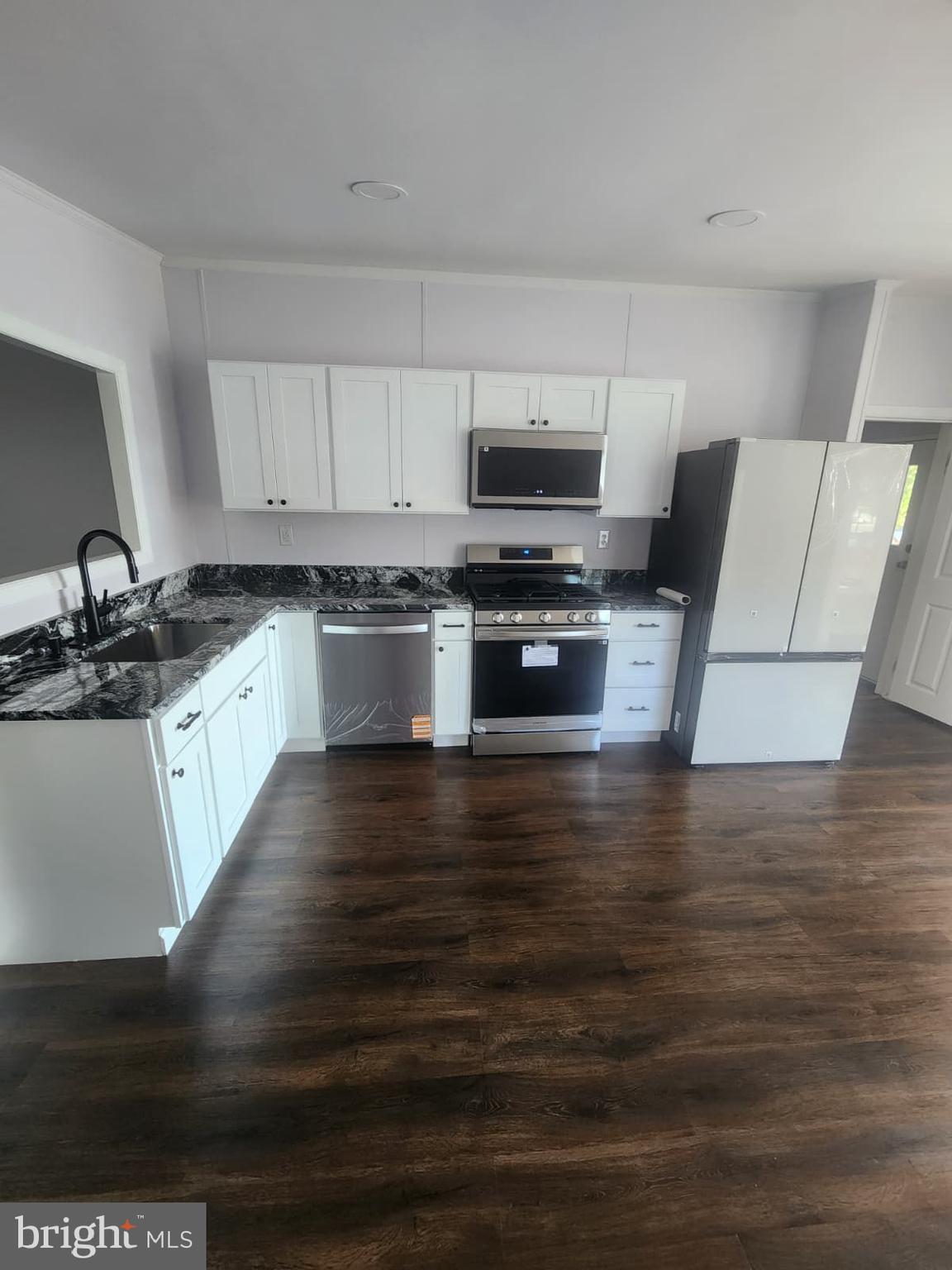2110 Mays Landing Road, Unit 199 Millville, NJ 08332 - Photo 18 of 18 a kitchen with granite countertop a stove and a sink