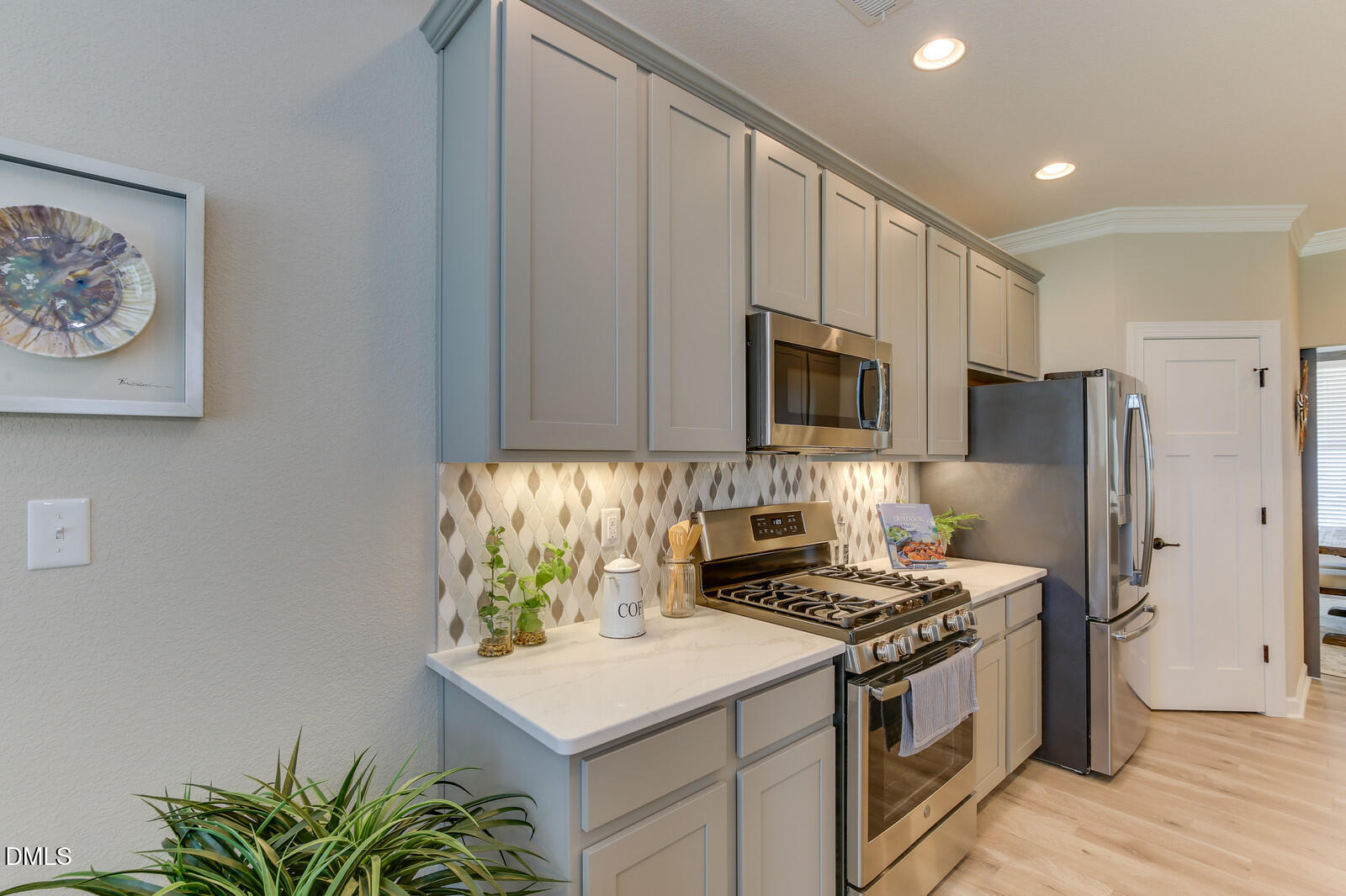 116 Brooklynn Trail Angier, NC 27501 - Photo 8 of 28 a kitchen with stainless steel appliances a stove a microwave sink and refrigerator