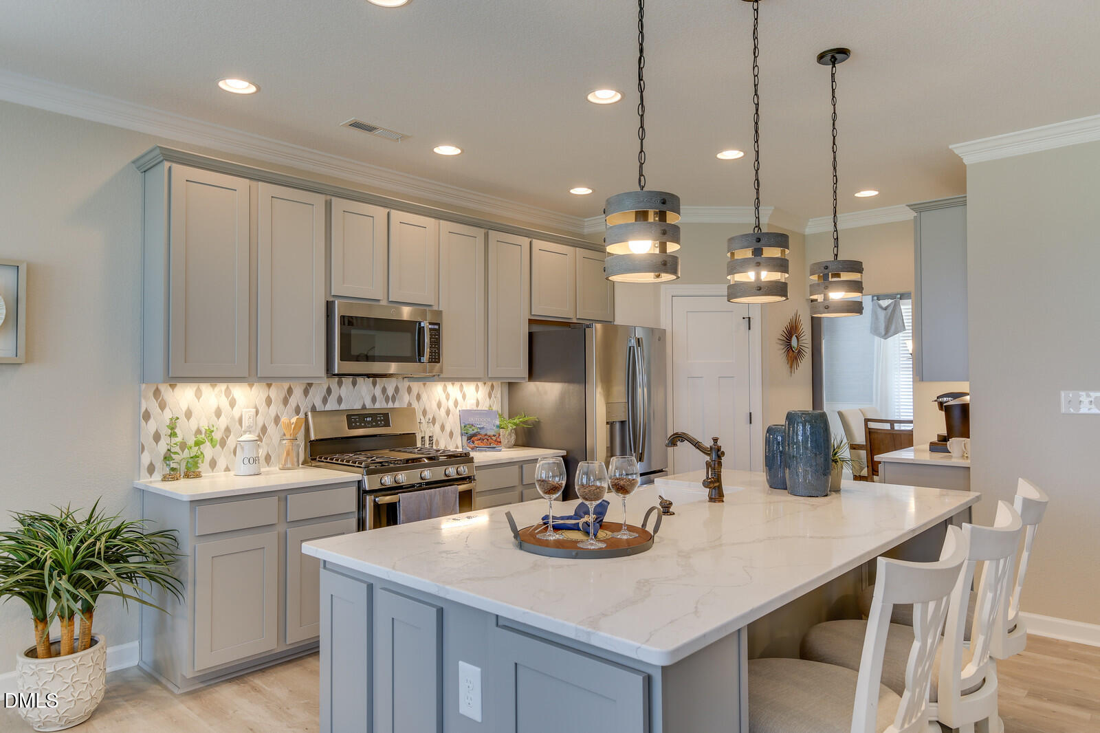 116 Brooklynn Trail Angier, NC 27501 - Photo 9 of 28 a kitchen with kitchen island a sink table and chairs
