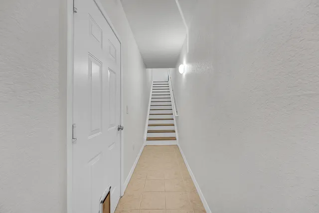 a view of a hallway with stairs
