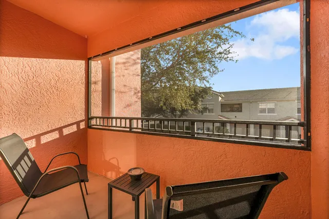 a view of a balcony with chairs