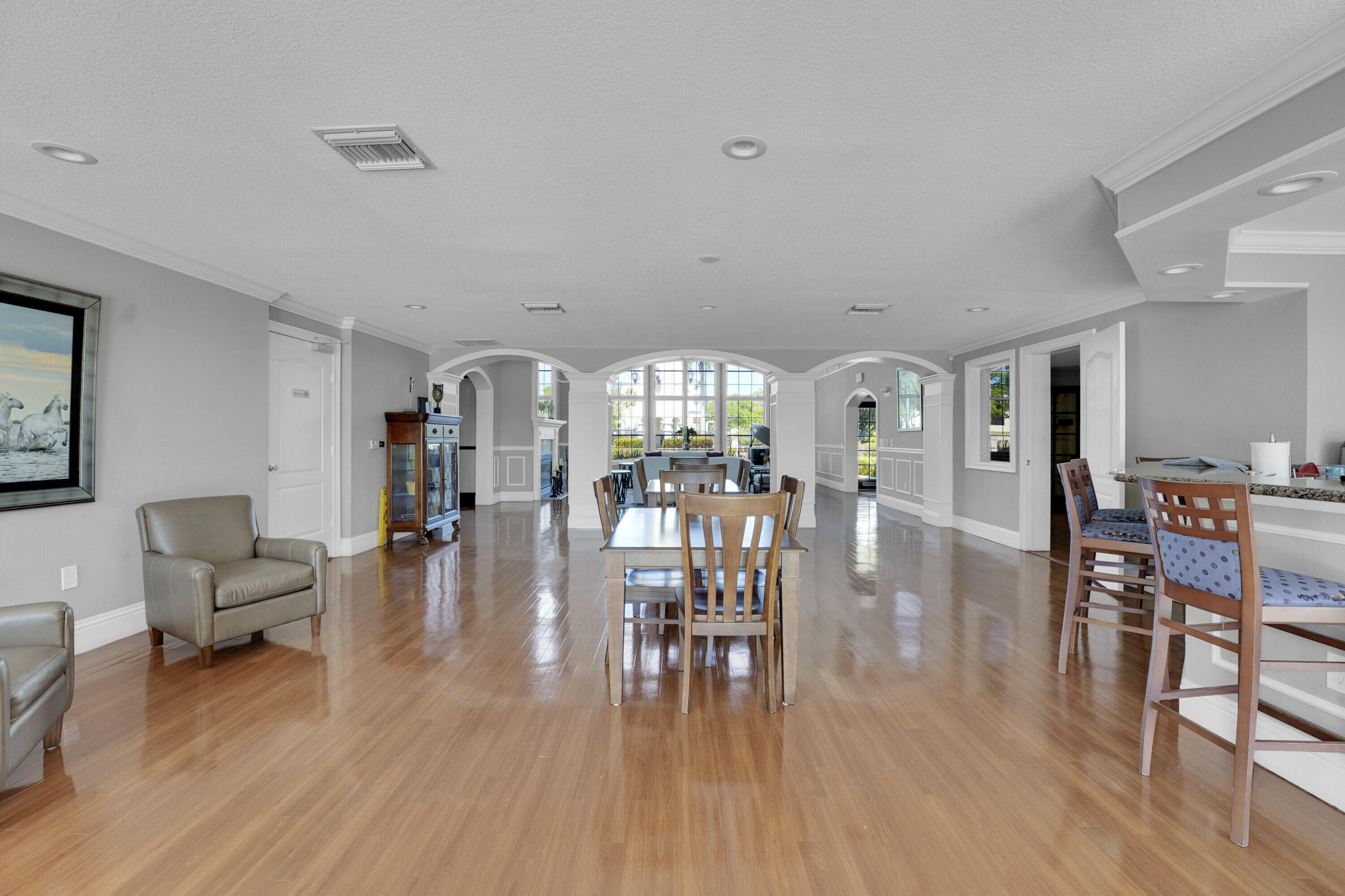 162 Southwest Peacock Boulevard, Unit 32206 Port St. Lucie, FL 34986 - Photo 18 of 24 a living room with furniture and wooden floor