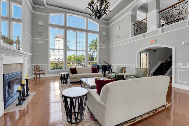 a living room with fireplace furniture and a large window