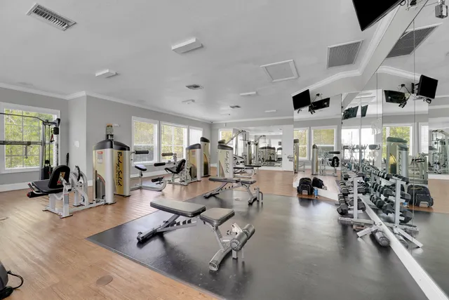 a living room with lots of furniture and a large window