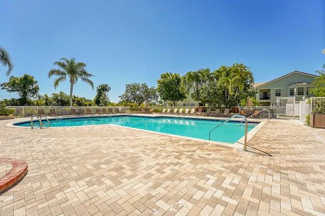 a view of a house with a swimming pool and a yard