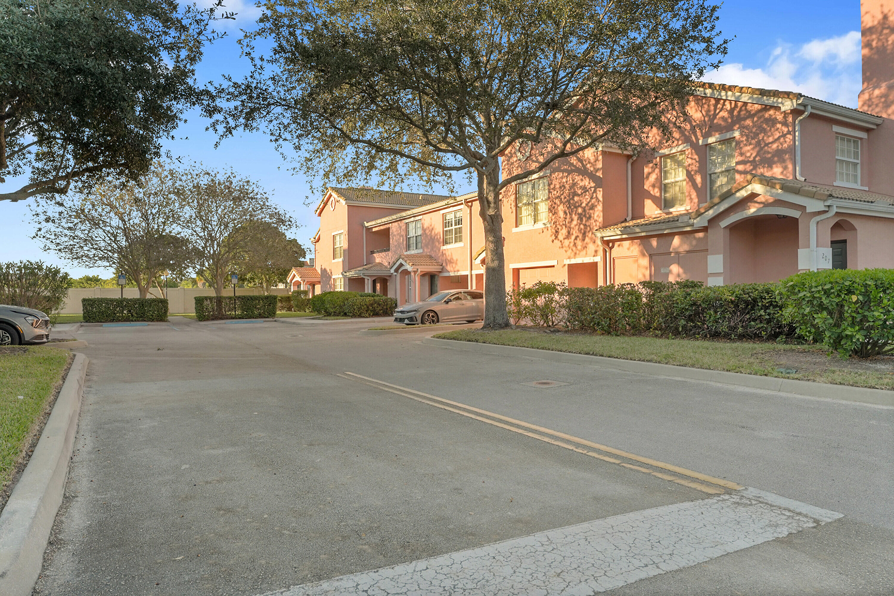 162 Southwest Peacock Boulevard, Unit 32206 Port St. Lucie, FL 34986 - Photo 3 of 24 a view of a street with a building in the background