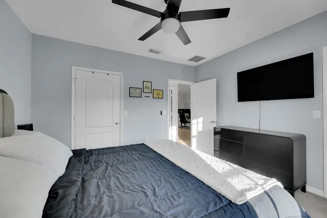 a bedroom with a bed and a flat screen tv
