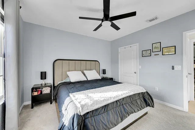 a bedroom with a bed and a chandelier