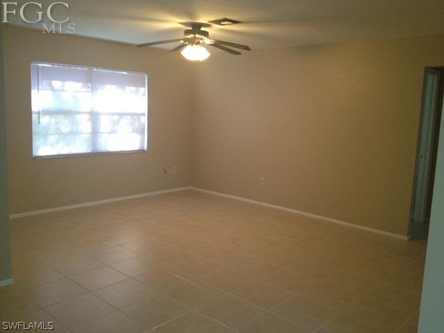 19173 Coconut Road Fort Myers, FL 33967 - Photo 3 of 7 en empty room with windows and fan