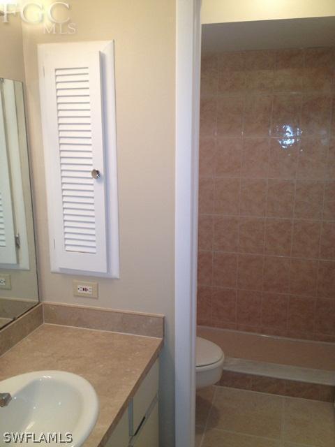 19173 Coconut Road Fort Myers, FL 33967 - Photo 6 of 7 a bathroom with a granite countertop sink toilet and shower