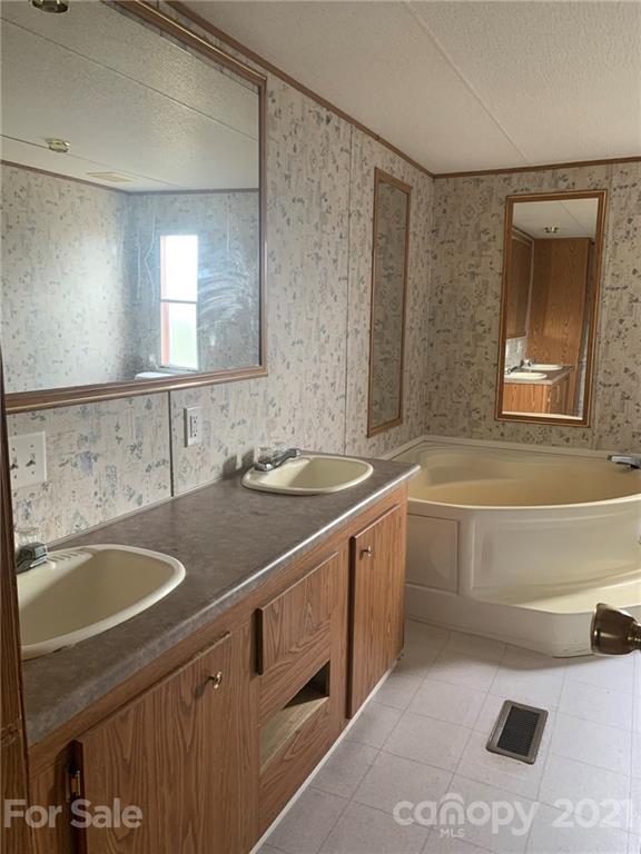 4524 Cherrystone Road Lancaster, SC 29720 - Photo 18 of 25 a bathroom with a sink a bathtub and a mirror