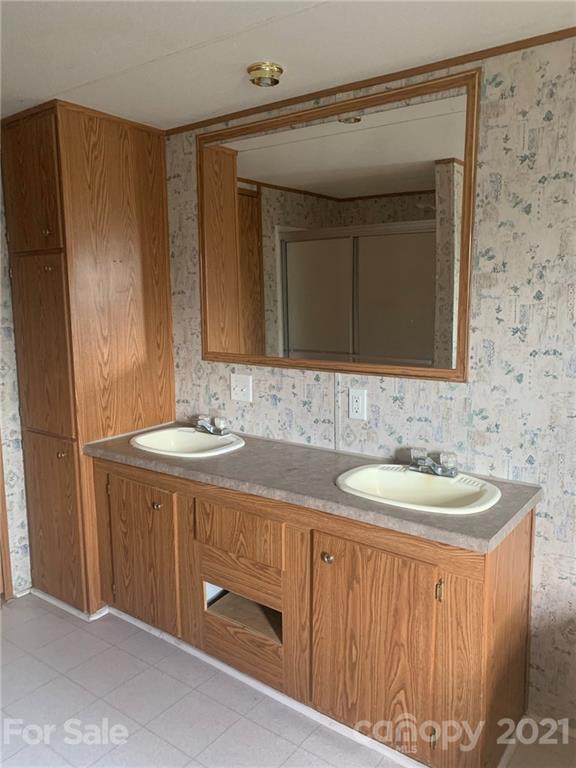 4524 Cherrystone Road Lancaster, SC 29720 - Photo 21 of 25 a bathroom with a double vanity sink and mirror