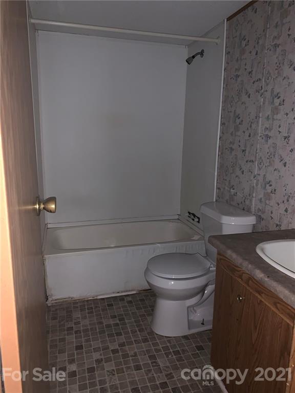 4524 Cherrystone Road Lancaster, SC 29720 - Photo 22 of 25 a bathroom with a granite countertop toilet and a sink