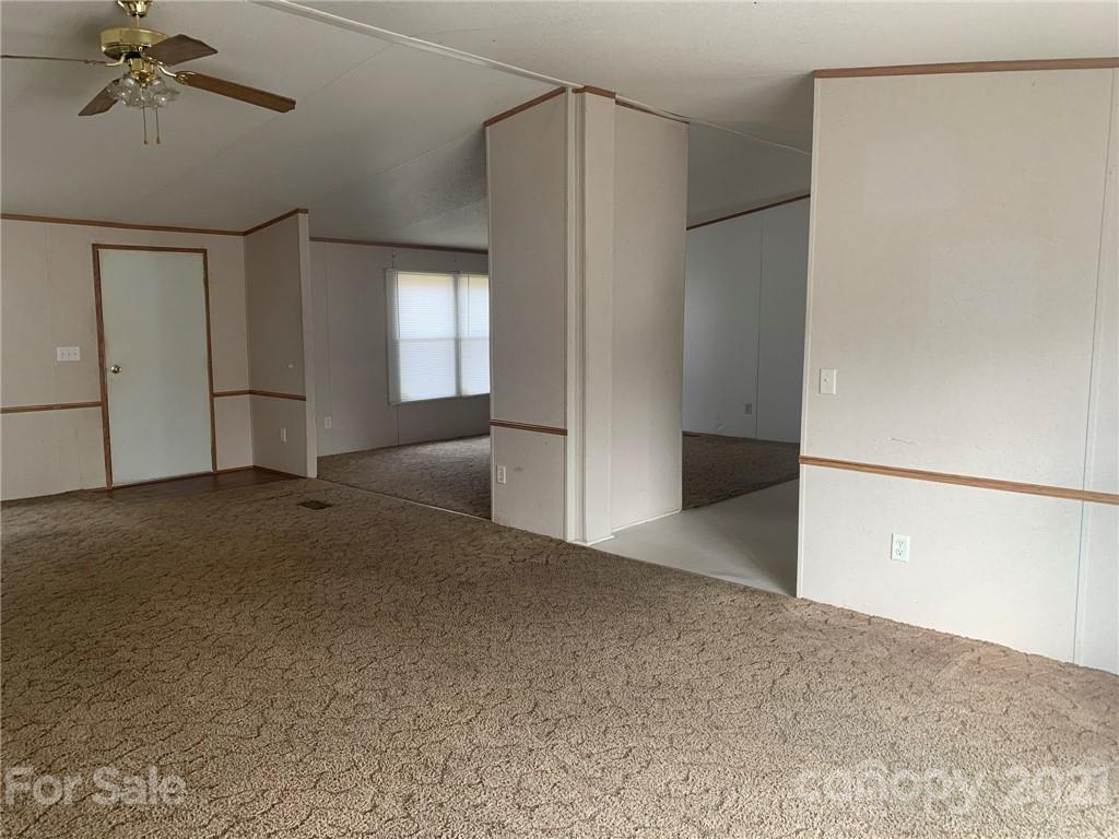 4524 Cherrystone Road Lancaster, SC 29720 - Photo 4 of 25 a view of a big room with windows and chandelier fan
