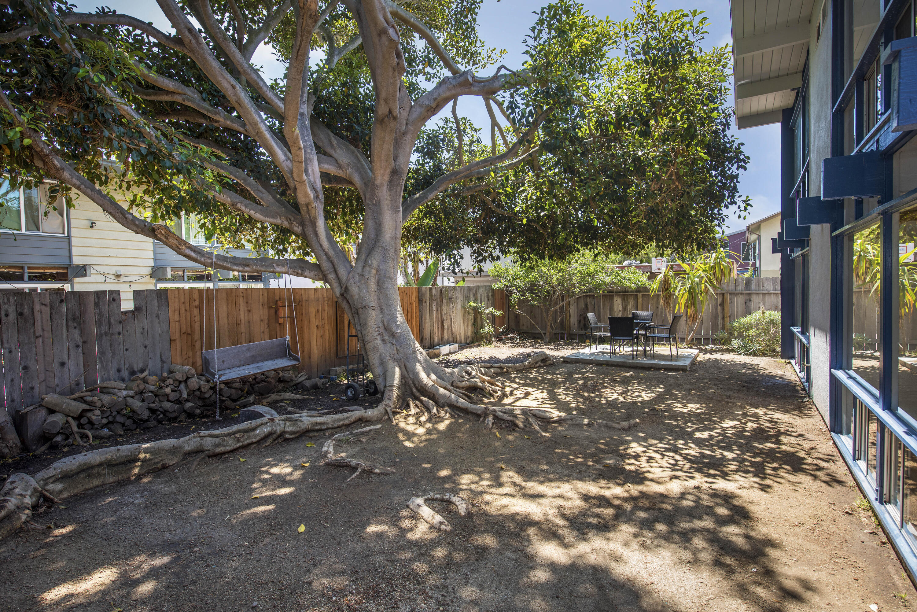 6711 Sabado Tarde Road Goleta, CA 93117 - Photo 2 of 9 a view of a backyard with large trees and a barn