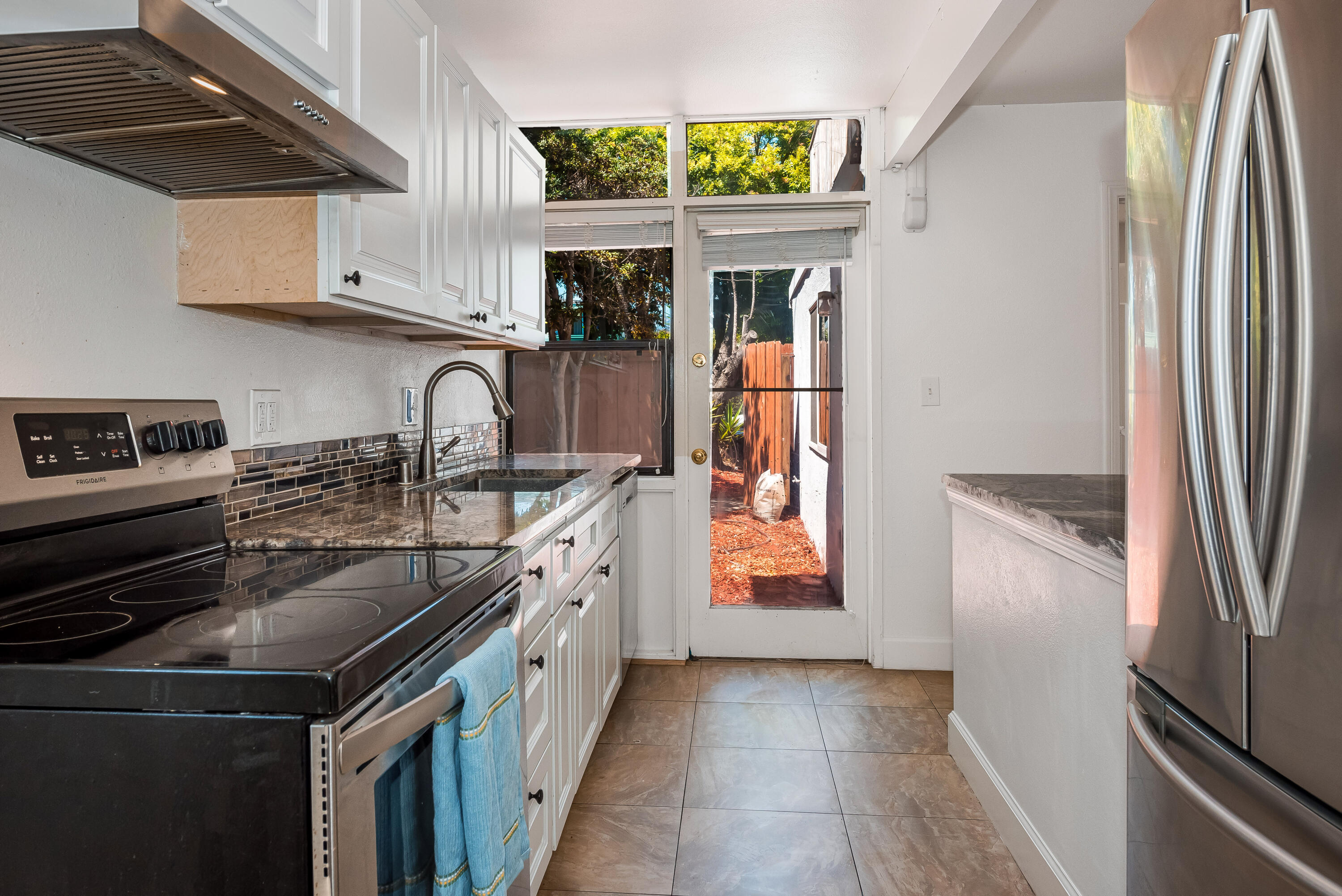 6711 Sabado Tarde Road Goleta, CA 93117 - Photo 4 of 9 a kitchen with stainless steel appliances granite countertop a refrigerator and a stove
