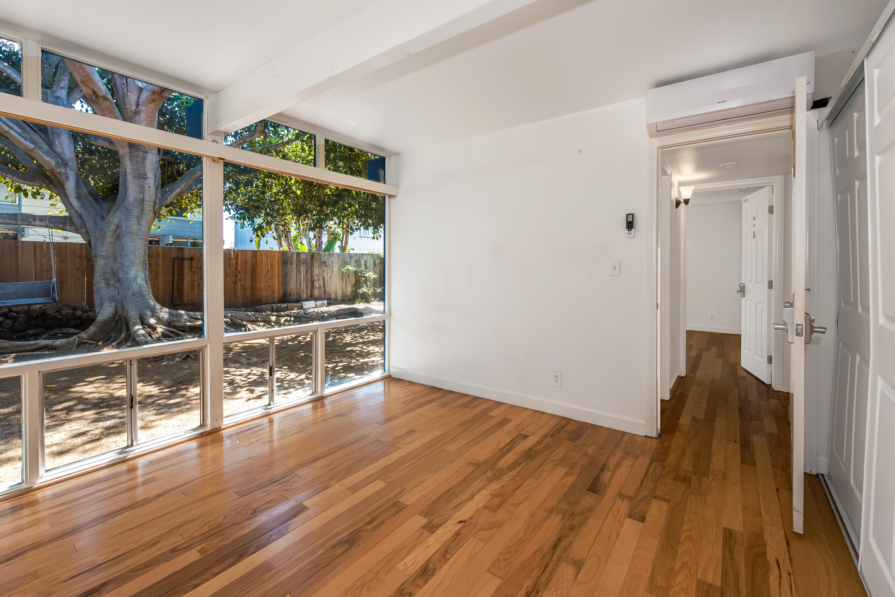 6711 Sabado Tarde Road Goleta, CA 93117 - Photo 5 of 9 an empty room with wooden floor and windows