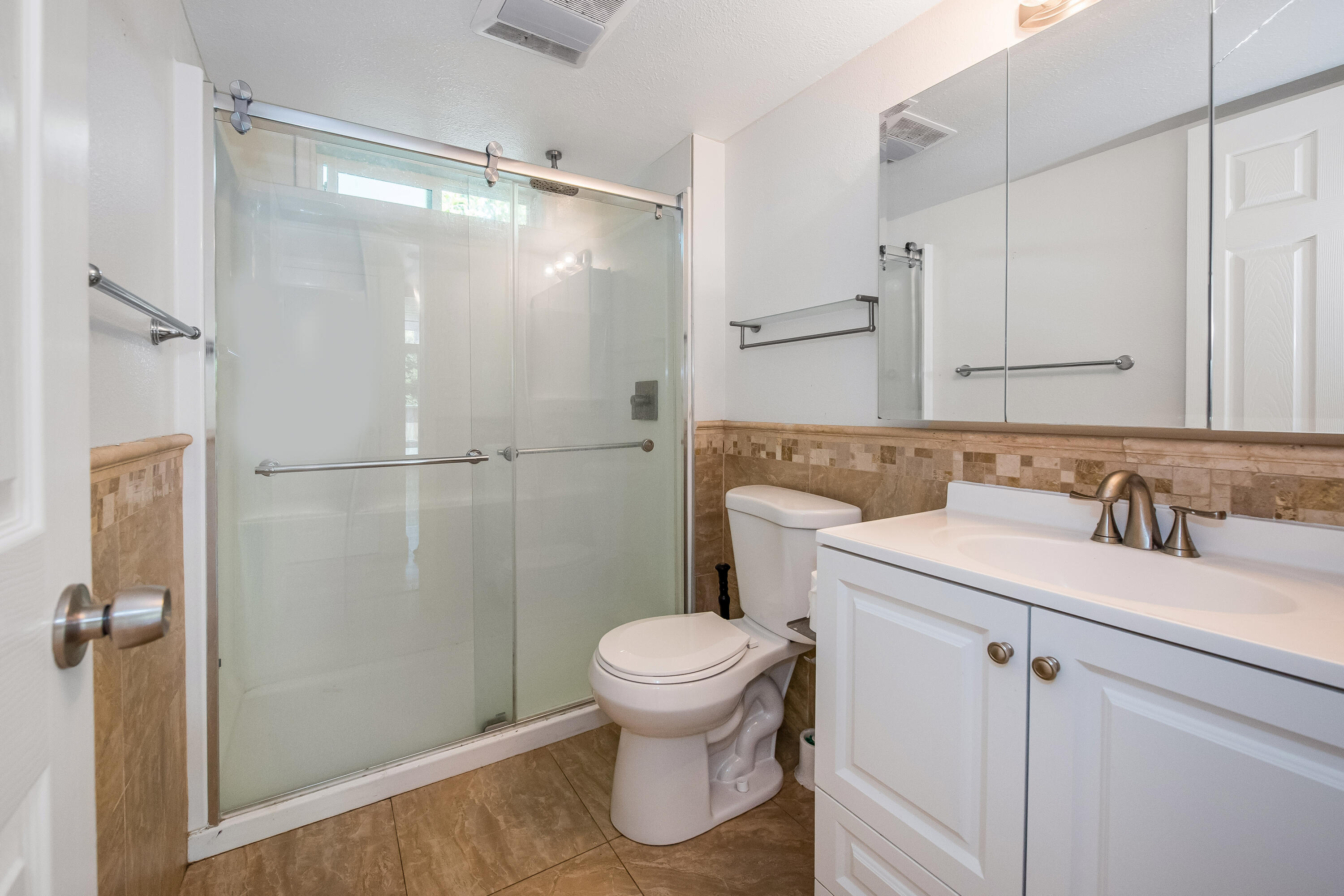 6711 Sabado Tarde Road Goleta, CA 93117 - Photo 8 of 9 a bathroom with a granite countertop sink toilet and shower