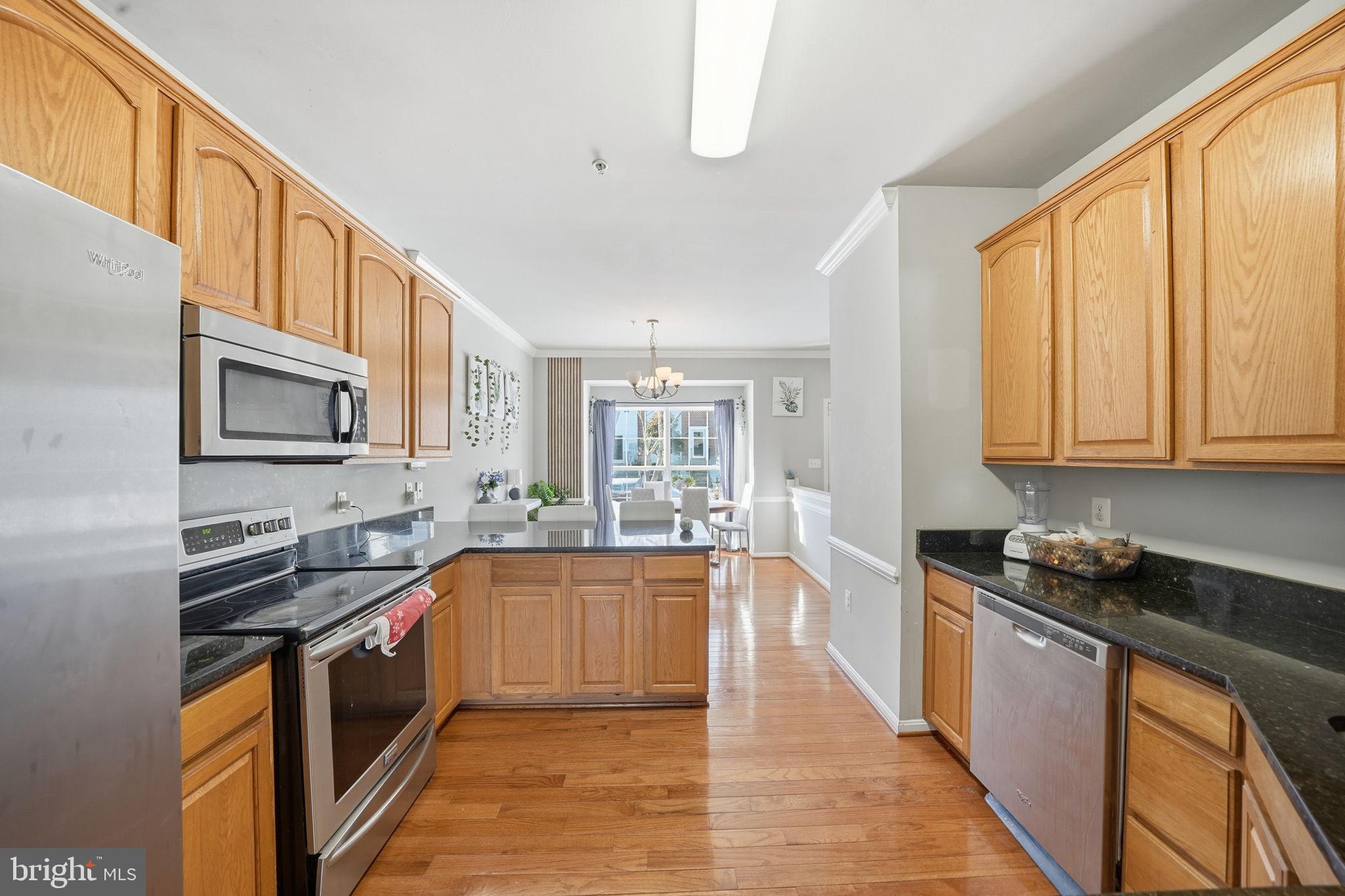 15420 Kennett Square Way Brandywine, MD 20613 - Photo 12 of 32 a kitchen with stainless steel appliances a stove sink microwave and cabinets