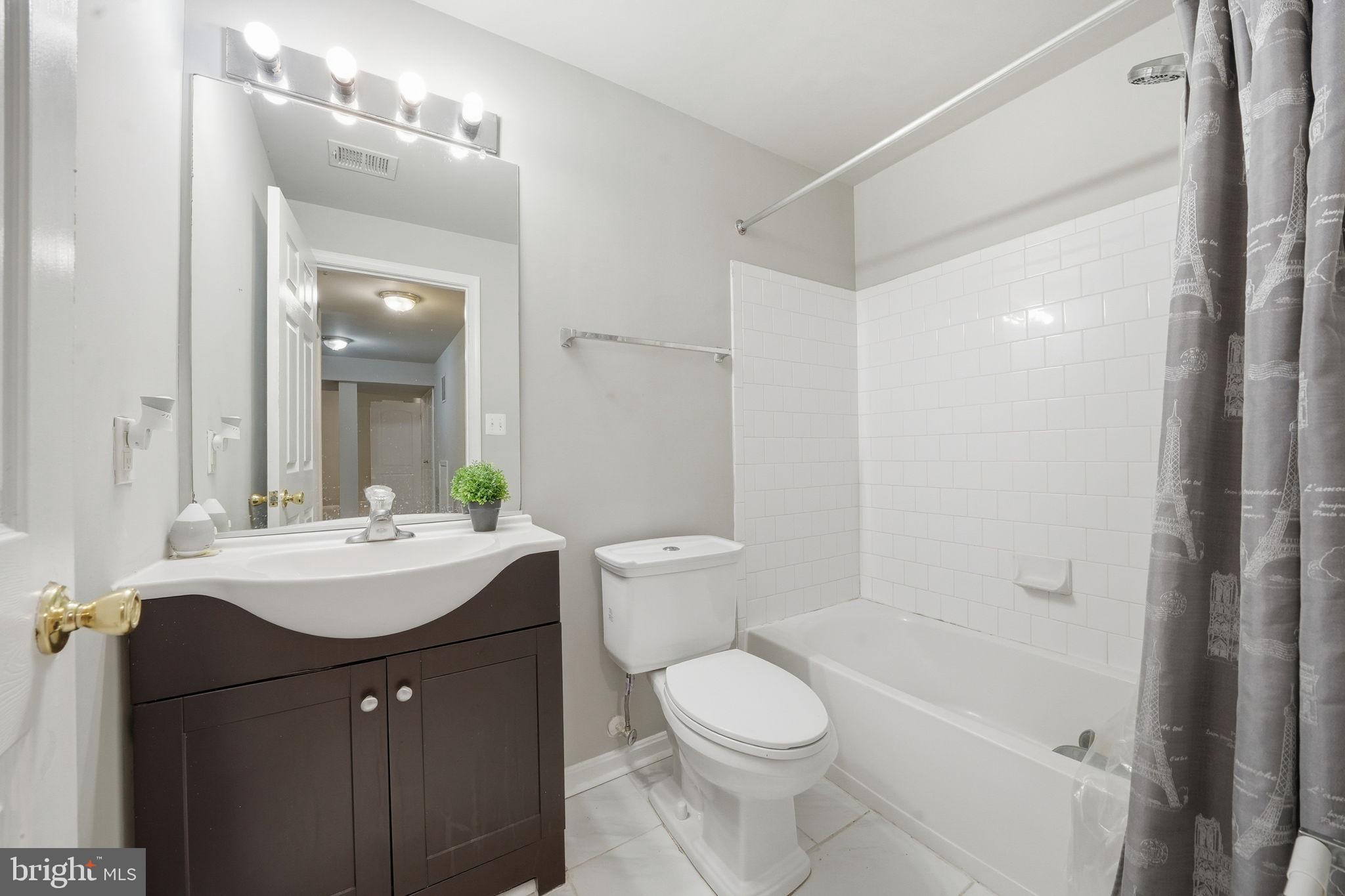 15420 Kennett Square Way Brandywine, MD 20613 - Photo 24 of 32 a bathroom with a sink a toilet and shower