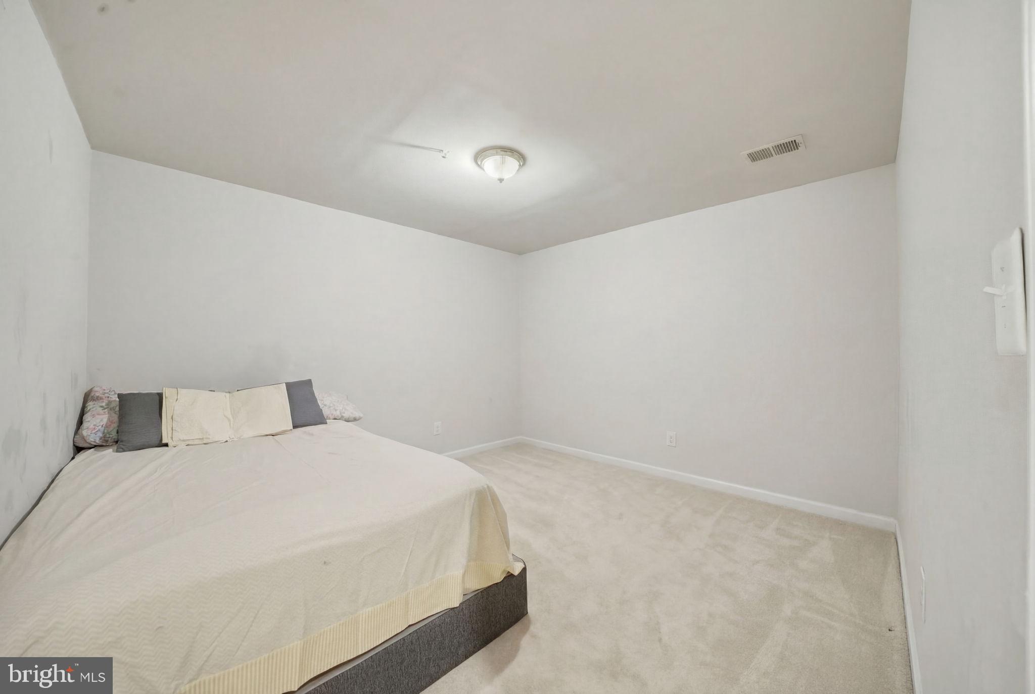 15420 Kennett Square Way Brandywine, MD 20613 - Photo 25 of 32 a bedroom with a bed and a night stand