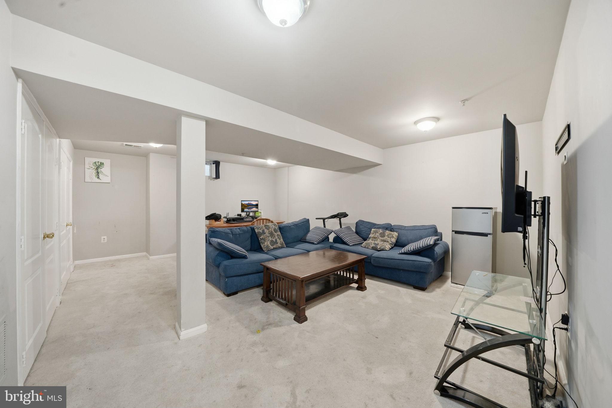 15420 Kennett Square Way Brandywine, MD 20613 - Photo 26 of 32 a living room with furniture and a wooden floor
