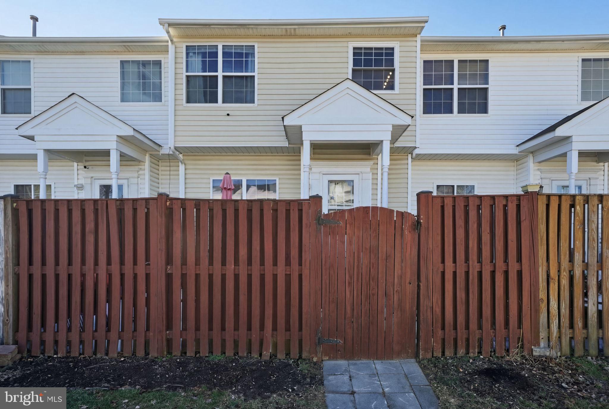 15420 Kennett Square Way Brandywine, MD 20613 - Photo 29 of 32 a front view of a house with wooden fence