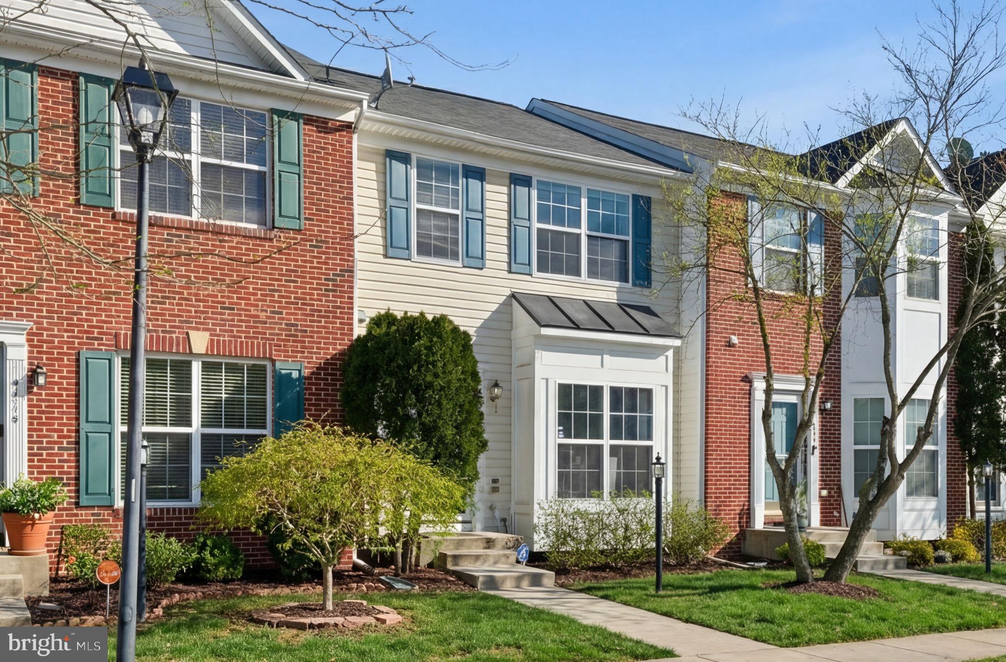 15420 Kennett Square Way Brandywine, MD 20613 - Photo 4 of 32 a view of a house with brick walls and a yard with plants