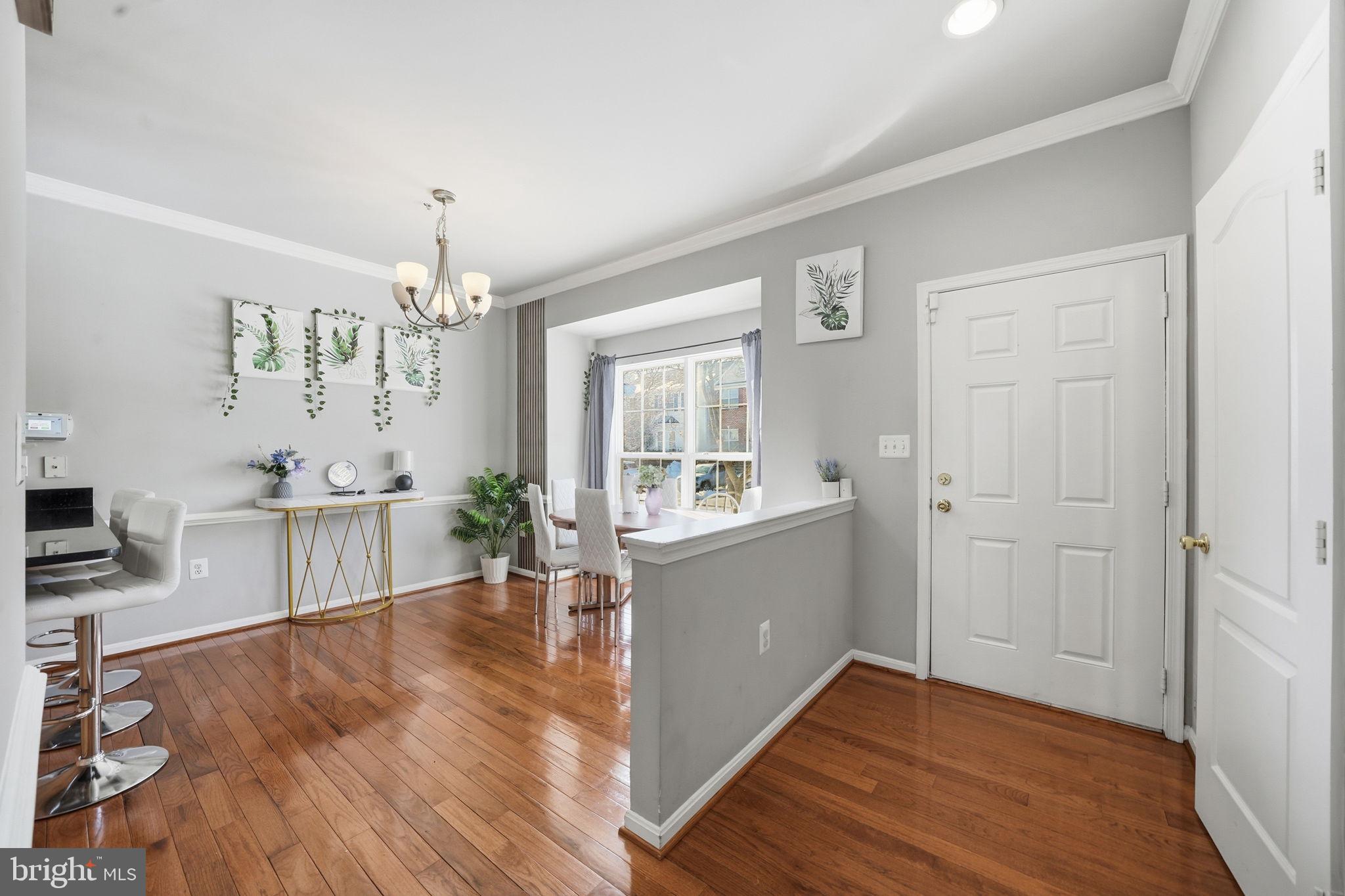 15420 Kennett Square Way Brandywine, MD 20613 - Photo 7 of 32 a view of a living room and kitchen with wooden floor