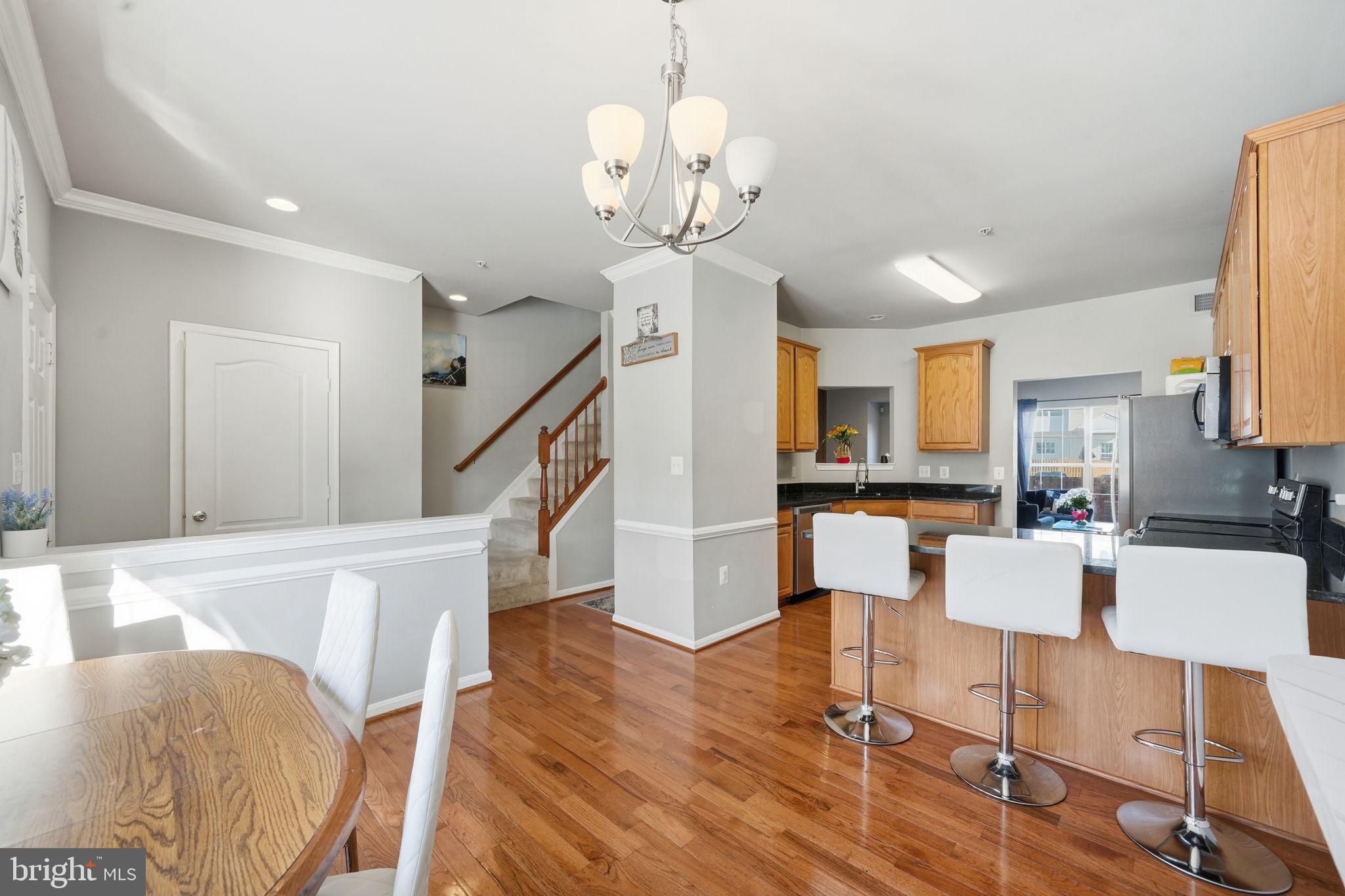 15420 Kennett Square Way Brandywine, MD 20613 - Photo 9 of 32 a view of a dining room with furniture and wooden floor