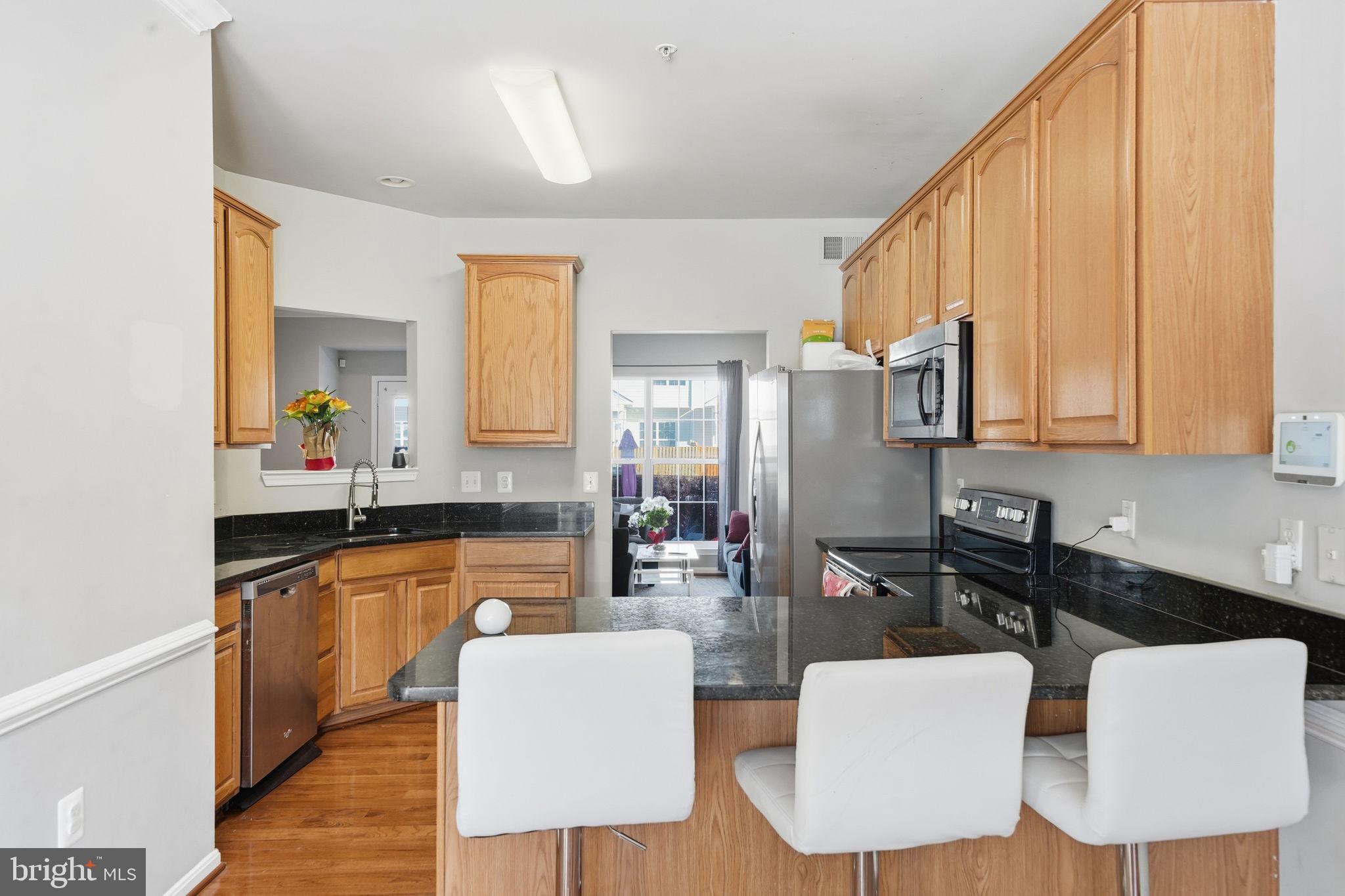 15420 Kennett Square Way Brandywine, MD 20613 - Photo 10 of 32 a kitchen with a table chairs sink and cabinets