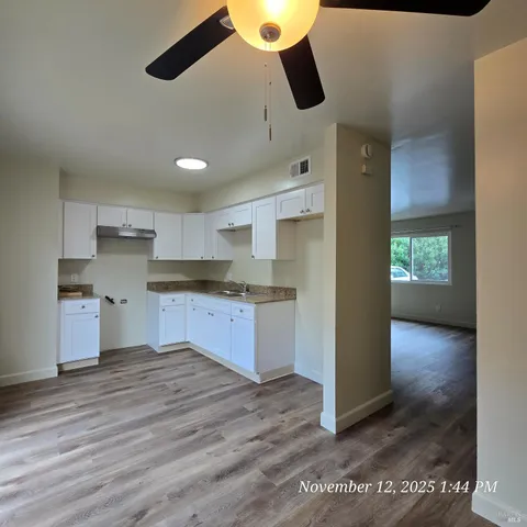 a kitchen with granite countertop a stove and a refrigerator
