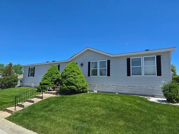 a view of house with backyard and garden