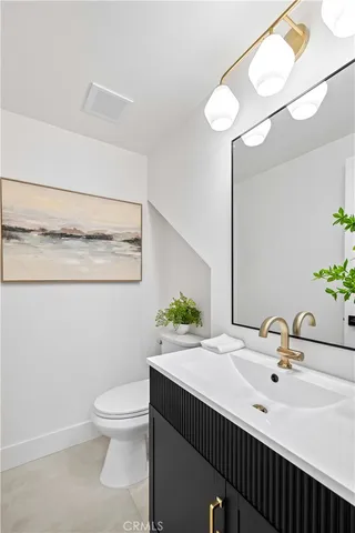 a bathroom with a sink toilet and a mirror