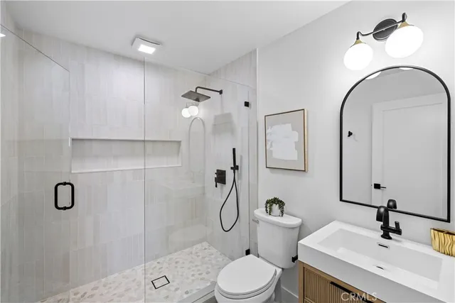 a bathroom with a toilet sink shower and mirror