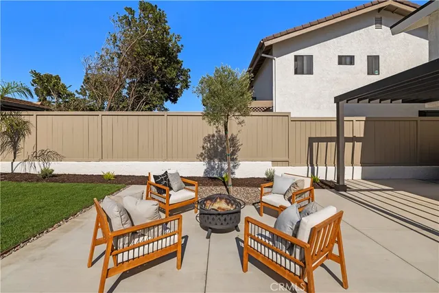 a view of a backyard with swimming pool and sitting area