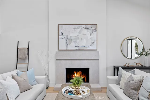 a living room with furniture a fireplace and wall paintings