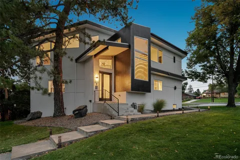 a view of a house with a yard and tree s