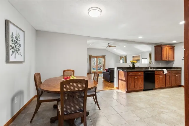 a kitchen with stainless steel appliances granite countertop a stove a sink a dining table and chairs