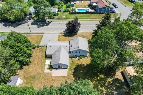 an aerial view of a house with garden space and lake view