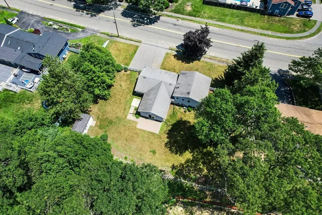 an aerial view of a house with a garden and swimming pool